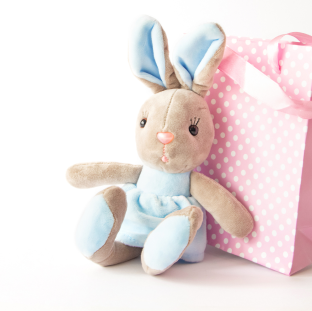 stuffed-plush-rabbit-pink-gift-bag-white-background-concept-childhood-birthday-gift-copy-space 1